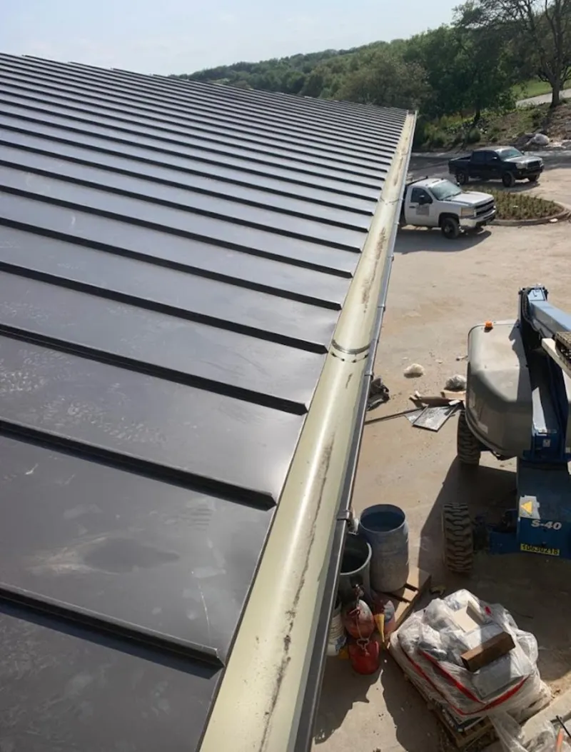 Standing seam panel and gutter detail on a metal roofing jobsite in Whitestown